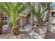 Charming condo entrance with well-maintained walkway and lush palm trees at 5250 S Rainbow Blvd # 2165, Las Vegas, NV 89118