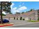 Exterior view of townhomes with private garages, neat landscaping, and ample parking space at 5250 S Rainbow Blvd # 2165, Las Vegas, NV 89118