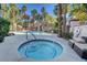 Inviting hot tub next to the community pool, surrounded by lush landscaping and seating areas at 5250 S Rainbow Blvd # 2165, Las Vegas, NV 89118