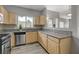 Well-lit kitchen with stainless steel dishwasher, light wood cabinets and granite countertops at 5250 S Rainbow Blvd # 2165, Las Vegas, NV 89118