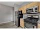 Kitchen includes black gas range oven, stainless steel fridge and over the range microwave at 5250 S Rainbow Blvd # 2165, Las Vegas, NV 89118