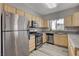 Well-lit kitchen featuring stainless steel appliances, stylish cabinets, and granite countertops at 5250 S Rainbow Blvd # 2165, Las Vegas, NV 89118