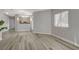 Inviting living room boasts wood-look floors, access to the kitchen, and a sunlit window at 5250 S Rainbow Blvd # 2165, Las Vegas, NV 89118