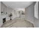 Open living room features fireplace, neutral paint, and modern flooring at 5250 S Rainbow Blvd # 2165, Las Vegas, NV 89118