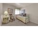 Cozy bedroom features a rocking chair, daybed, and soft neutral color palette at 5846 Dana Rogers Dr, Las Vegas, NV 89110