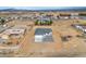 An aerial view of the property, showcasing the house, neighborhood, and the desert landscape at 60 E Jaybird St, Pahrump, NV 89048