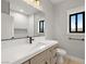 Bathroom featuring a vanity with a white countertop, black fixtures, and a large mirror at 60 E Jaybird St, Pahrump, NV 89048