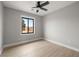 This bedroom features light gray walls, wood-look flooring, and a large window at 60 E Jaybird St, Pahrump, NV 89048