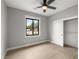 This bedroom features light gray walls, wood-look flooring, and a window with a view at 60 E Jaybird St, Pahrump, NV 89048
