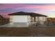 Charming single-story home boasts a well-manicured lawn and inviting curb appeal at 60 E Jaybird St, Pahrump, NV 89048