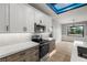Well-equipped kitchen with stainless steel appliances, island seating, and stylish lighting at 60 E Jaybird St, Pahrump, NV 89048