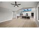 Open-concept kitchen and living area with a large island and modern lighting at 60 E Jaybird St, Pahrump, NV 89048