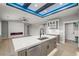 Open-concept living space with modern kitchen island, fireplace, and ample natural light at 60 E Jaybird St, Pahrump, NV 89048