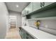 Practical mud room featuring overhead cabinets, counter space, and easy access to storage at 60 E Jaybird St, Pahrump, NV 89048