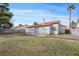 Exterior view of the home showing a large yard with a brick patio at 6413 Chippindale Ln, Las Vegas, NV 89108