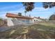 View of the backyard showing a grass area, concrete patio and brick-paved walkway at 6413 Chippindale Ln, Las Vegas, NV 89108