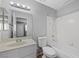 Standard bathroom featuring a vanity, toilet, and shower-tub combination with white tile surround at 6413 Chippindale Ln, Las Vegas, NV 89108