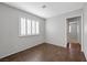 Spacious bedroom offers hardwood flooring, a window with blinds and neutral walls at 6413 Chippindale Ln, Las Vegas, NV 89108