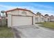 Exterior view of a two-car garage, with lawn and a peek of the home next door at 6413 Chippindale Ln, Las Vegas, NV 89108