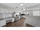 Bright kitchen features white cabinetry, stainless steel appliances, and a tiled floor at 6413 Chippindale Ln, Las Vegas, NV 89108