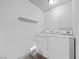 Laundry room with white washer and dryer, and a shelf at 6413 Chippindale Ln, Las Vegas, NV 89108