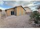 The backyard has a low-maintenance gravel, a paved patio area, and desert landscaping at 6533 Adonis Heights Ave, North Las Vegas, NV 89086