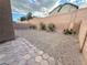 Backyard featuring low-maintenance desert landscaping and a block wall for privacy at 6533 Adonis Heights Ave, North Las Vegas, NV 89086