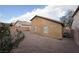 The backyard has gravel, sparse vegetation, a paved patio, and is surrounded by block fencing at 6533 Adonis Heights Ave, North Las Vegas, NV 89086