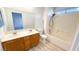 Bathroom featuring a double sink vanity, toilet, and shower-tub combo with a shower head at 6533 Adonis Heights Ave, North Las Vegas, NV 89086