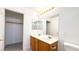 Bathroom featuring a double sink vanity with a large mirror, closet and toilet at 6533 Adonis Heights Ave, North Las Vegas, NV 89086