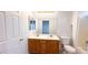 Bathroom featuring a double sink vanity with a wood finish and a large mirror at 6533 Adonis Heights Ave, North Las Vegas, NV 89086
