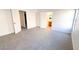 Bright bedroom with neutral carpet and white trim with ensuite bathroom views through open door at 6533 Adonis Heights Ave, North Las Vegas, NV 89086