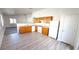 Kitchen featuring wood cabinets, white appliances, and fresh white paint at 6533 Adonis Heights Ave, North Las Vegas, NV 89086