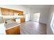 Kitchen featuring wood cabinets, white appliances, and sliding glass doors at 6533 Adonis Heights Ave, North Las Vegas, NV 89086