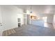 View of the living room that features fresh white paint and new carpets at 6533 Adonis Heights Ave, North Las Vegas, NV 89086