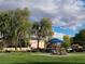 Neighborhood park with playground, picnic tables, mature trees, and community homes in the background at 6533 Adonis Heights Ave, North Las Vegas, NV 89086