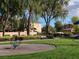 Community playground with mature trees, walking path, and ample green space near residential homes at 6533 Adonis Heights Ave, North Las Vegas, NV 89086