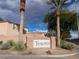 Tesoro community sign featuring manicured landscaping, palm trees, and desert plants at 6533 Adonis Heights Ave, North Las Vegas, NV 89086