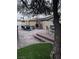 Outdoor living space with a brick fireplace and patio, creating a cozy retreat for gatherings and relaxation at 6775 Segura Dr, Las Vegas, NV 89103