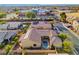 An aerial view of the backyard with a pool, patio, desert landscaping, and nearby recreational area at 7331 Abundant Harvest Ave, Las Vegas, NV 89131
