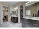 Bright bathroom with a soaking tub, double sinks, access to the main bedroom and the main closet at 7331 Abundant Harvest Ave, Las Vegas, NV 89131