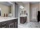 Bright bathroom featuring double sinks, white marble countertops, and tile floors at 7331 Abundant Harvest Ave, Las Vegas, NV 89131
