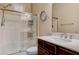 Bright bathroom featuring a glass-enclosed shower, white tile, and a modern vanity with marble countertop at 7331 Abundant Harvest Ave, Las Vegas, NV 89131