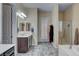 Well-lit bathroom with walk-in shower, large vanity and tile floors at 7331 Abundant Harvest Ave, Las Vegas, NV 89131