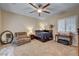 Cozy bedroom with a ceiling fan, plantation shutters, and plush carpeting, offering a relaxing retreat at 7331 Abundant Harvest Ave, Las Vegas, NV 89131