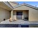 Inviting front entrance featuring a shaded patio with outdoor seating and decorative iron double doors at 7331 Abundant Harvest Ave, Las Vegas, NV 89131