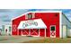 Charming red barn at Gilcrease Orchard, a local attraction, with white trim and signage for a rustic feel at 7331 Abundant Harvest Ave, Las Vegas, NV 89131