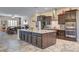 A kitchen with a center island and seating adjacent to an eat-in dining area at 7331 Abundant Harvest Ave, Las Vegas, NV 89131
