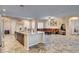 Large kitchen island with a sink, wood-look tile floors and an open floor plan at 7331 Abundant Harvest Ave, Las Vegas, NV 89131