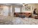 Cozy living room with a comfortable sectional, tile floors and plenty of natural light at 7331 Abundant Harvest Ave, Las Vegas, NV 89131